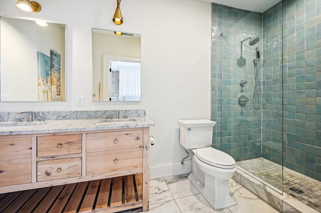 full bath with toilet, marble finish floors, tiled shower, double vanity, and baseboards