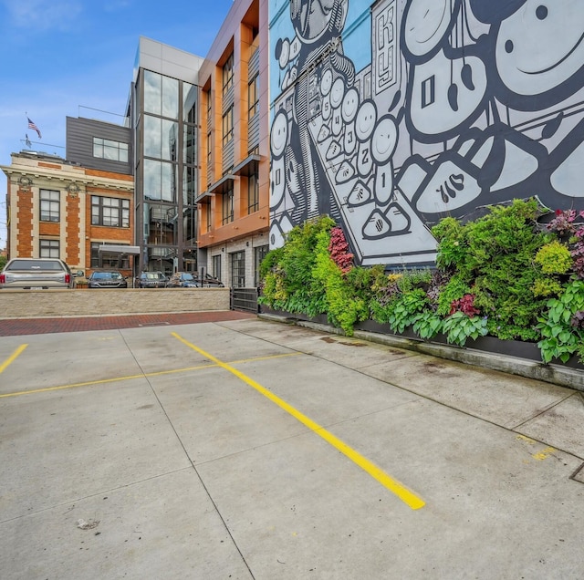 view of building exterior with uncovered parking