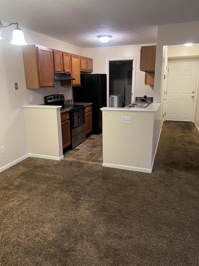 kitchen featuring freestanding refrigerator, a peninsula, dark carpet, under cabinet range hood, and stainless steel electric range oven