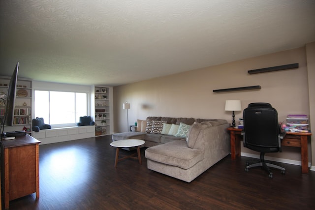 living room featuring a textured ceiling and dark wood-type flooring