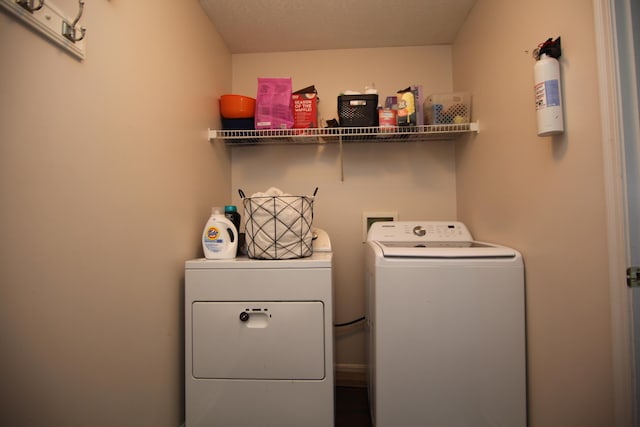 clothes washing area with laundry area and washing machine and clothes dryer