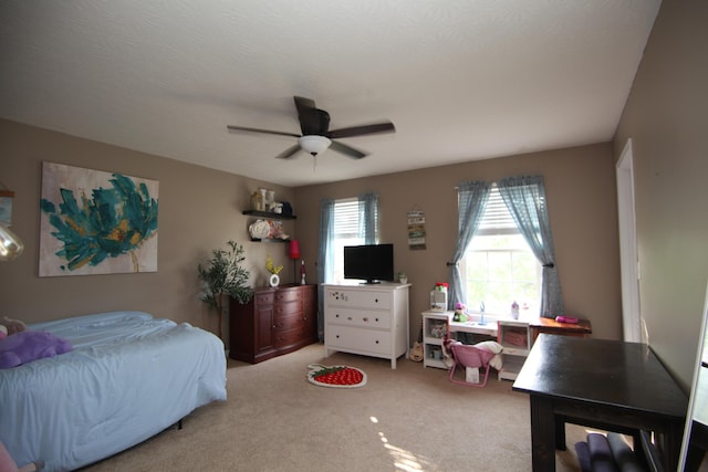 bedroom with a ceiling fan and light colored carpet