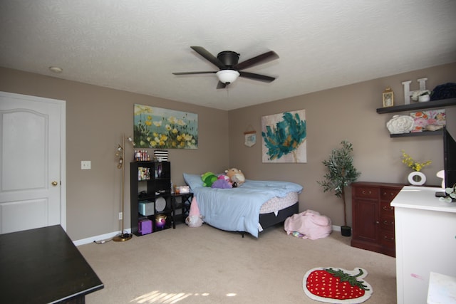 carpeted bedroom featuring baseboards and ceiling fan