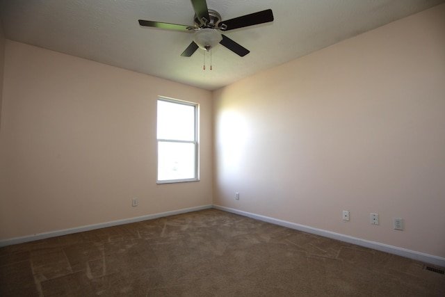 spare room featuring baseboards, ceiling fan, carpet flooring, and visible vents