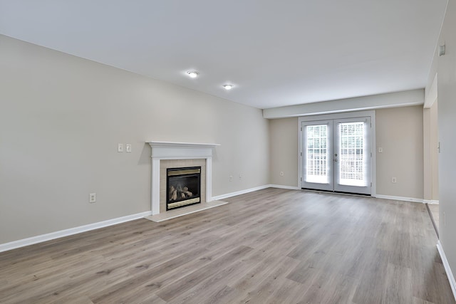 1609 Woodfield Ct, Hebron, KY 41048 - unfurnished living room with wood finished floors, a tile fireplace, and french doors