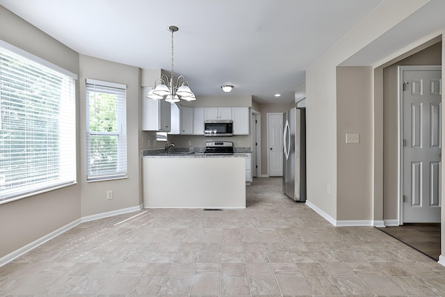 1609 Woodfield Ct, Hebron, KY 41048 - kitchen with appliances with stainless steel finishes, a chandelier, white cabinetry, a peninsula, and pendant lighting