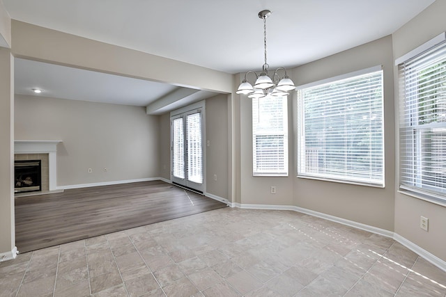 1609 Woodfield Ct, Hebron, KY 41048 - unfurnished dining area with a chandelier, a fireplace, and light tile patterned floors