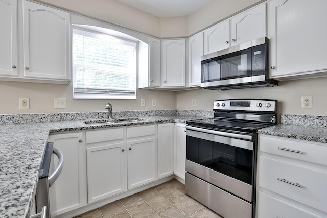 1609 Woodfield Ct, Hebron, KY 41048 - kitchen with stainless steel appliances, white cabinetry, and light stone counters