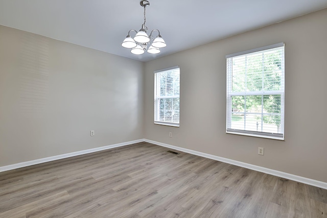 1609 Woodfield Ct, Hebron, KY 41048 - unfurnished room featuring a chandelier and light wood-style floors
