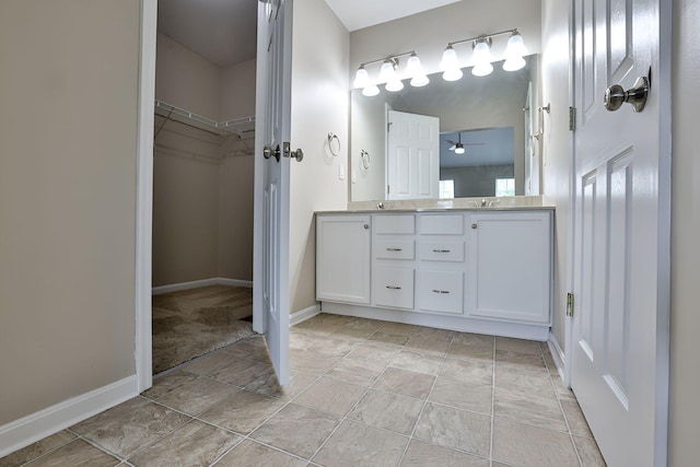1609 Woodfield Ct, Hebron, KY 41048 - bathroom with a ceiling fan, double vanity, stone finish flooring, and a spacious closet