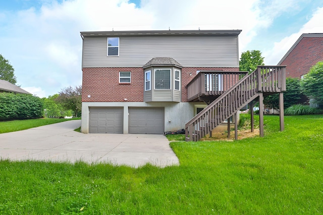 1609 Woodfield Ct, Hebron, KY 41048 - back of house with stairway, a deck, driveway, a garage, and a yard