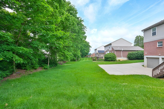 1609 Woodfield Ct, Hebron, KY 41048 - view of green lawn with concrete driveway and an attached garage
