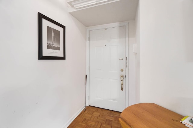 doorway to outside featuring baseboards
