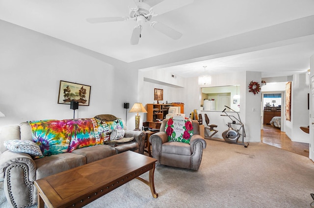 living room with carpet floors, ceiling fan, and baseboards