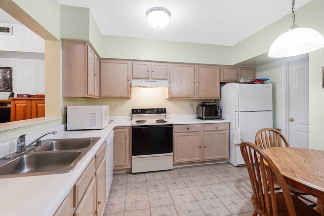 kitchen with white appliances, under cabinet range hood, a sink, light brown cabinetry, and light countertops