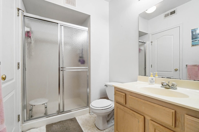 full bathroom with a shower stall, toilet, vanity, and tile patterned flooring