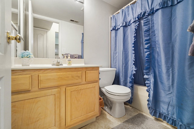bathroom with toilet, vanity, and shower / bath combo with shower curtain