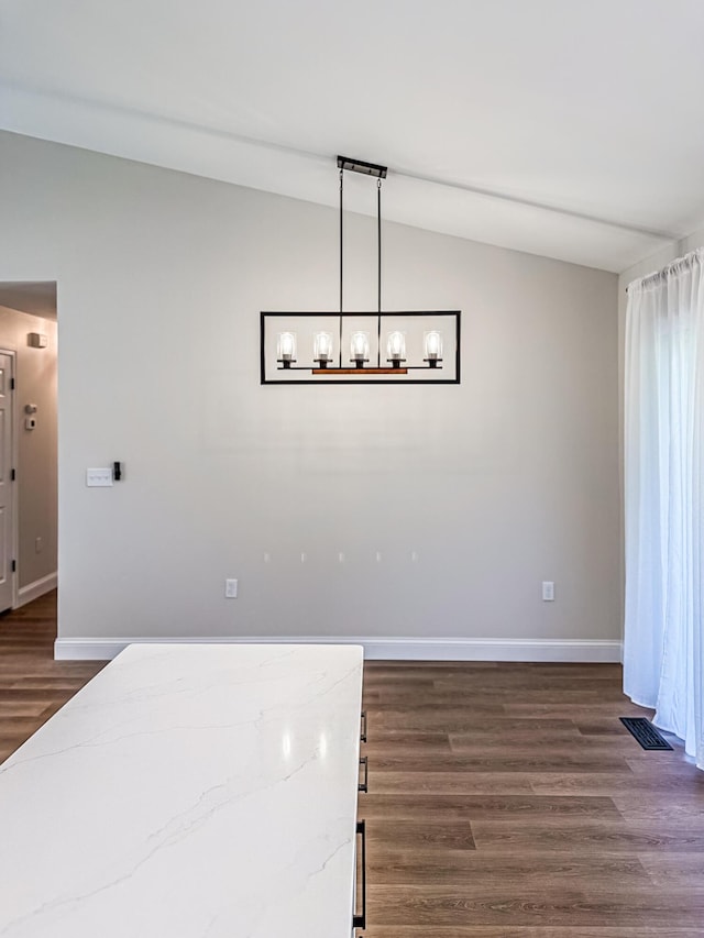 unfurnished dining area with a chandelier, baseboards, lofted ceiling, visible vents, and dark wood-style floors