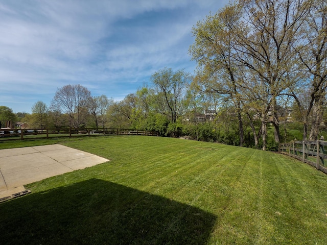 view of yard with fence and a patio