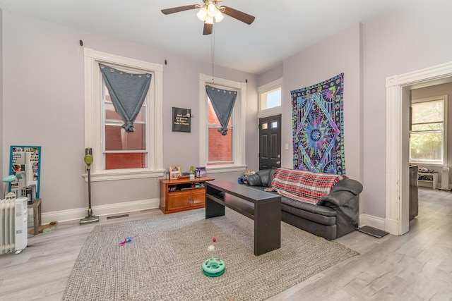 sitting room featuring baseboards, ceiling fan, wood finished floors, and visible vents