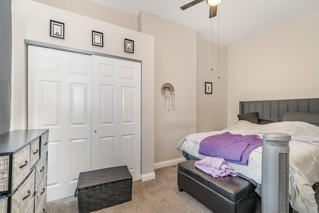bedroom with carpet flooring, baseboards, ceiling fan, and a closet