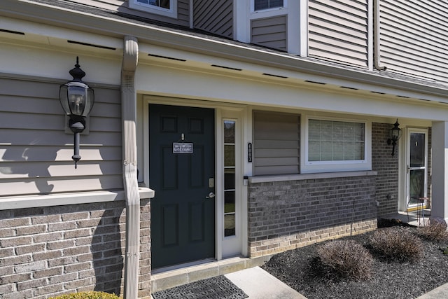 entrance to property with brick siding
