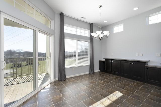 unfurnished dining area featuring recessed lighting, baseboards, a chandelier, and visible vents
