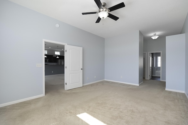 interior space with carpet floors, baseboards, and ceiling fan