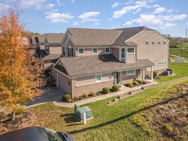 traditional-style home with central air condition unit, brick siding, driveway, and roof with shingles