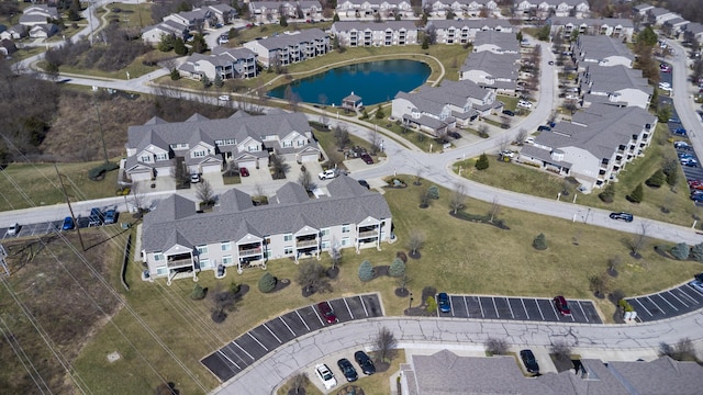 drone / aerial view with a water view and a residential view