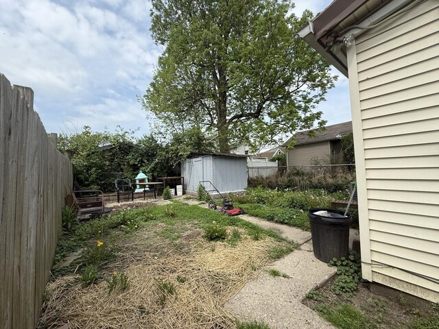 2749 Alexandria Ave, Covington, KY 41015 - view of yard with a fenced backyard, an outdoor structure, and a storage shed