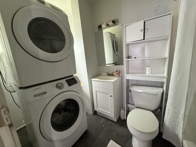 2749 Alexandria Ave, Covington, KY 41015 - bathroom with tile patterned floors, stacked washer and clothes dryer, vanity, and toilet