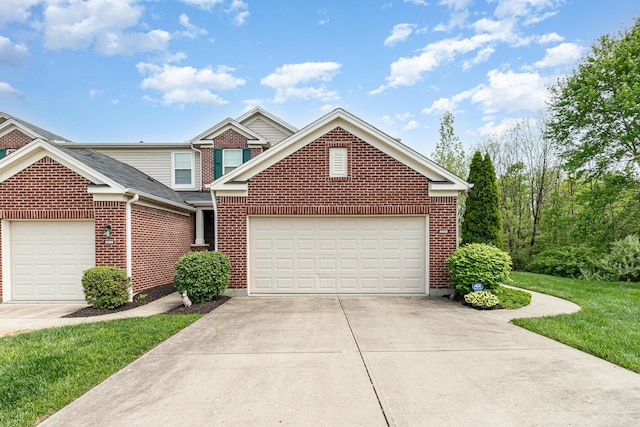 view of front of house featuring roof with shingles, brick siding, a garage, a front yard, and driveway