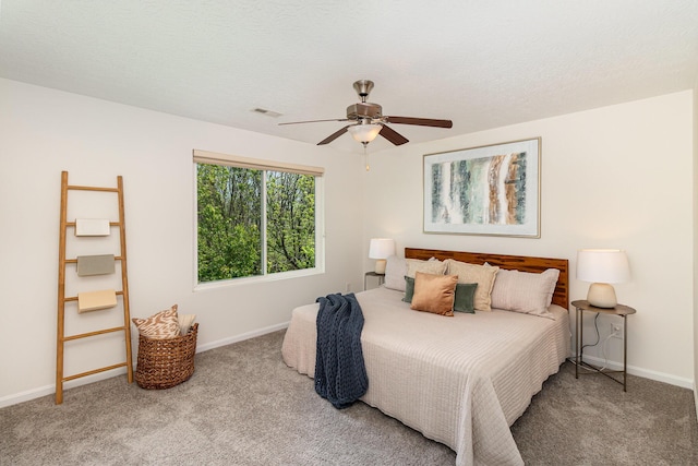 carpeted bedroom featuring baseboards, ceiling fan, and visible vents