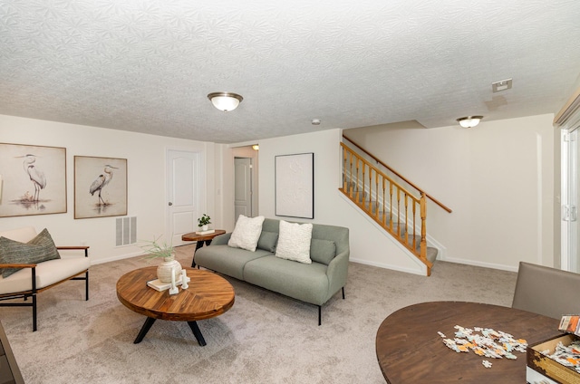living area with visible vents, carpet flooring, baseboards, and stairway