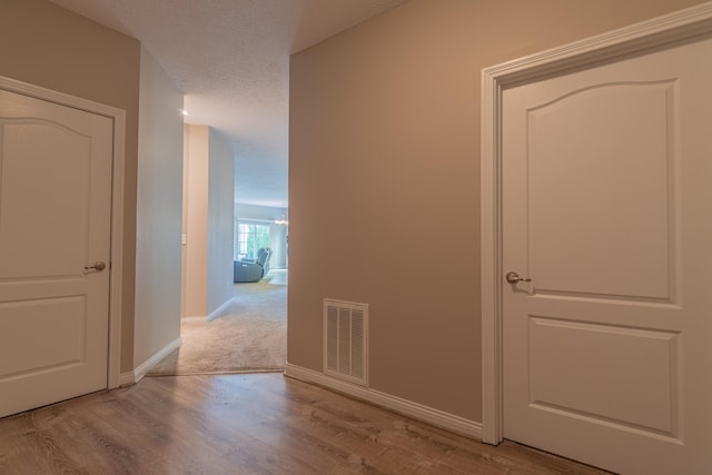 hall featuring wood finished floors and baseboards