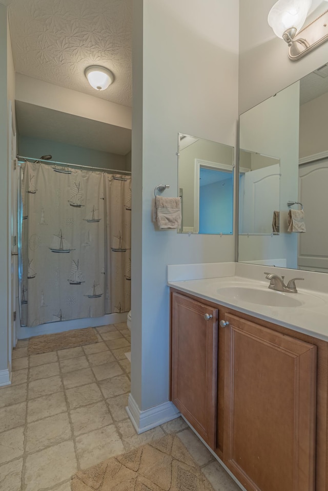 full bathroom with vanity, baseboards, toilet, and a shower with curtain