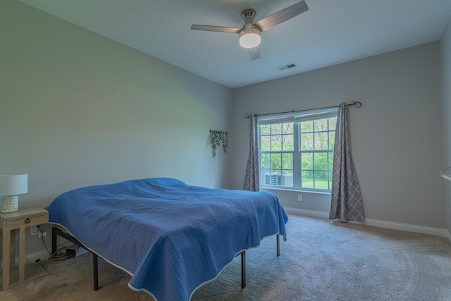 bedroom featuring baseboards, carpet flooring, and a ceiling fan