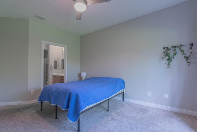bedroom featuring carpet floors, baseboards, ensuite bathroom, and ceiling fan