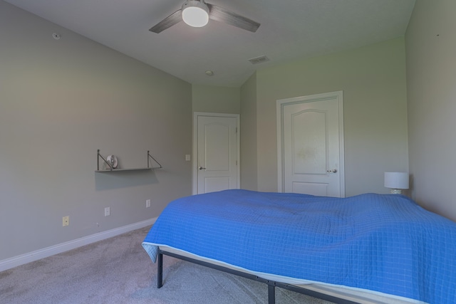 carpeted bedroom featuring baseboards and a ceiling fan