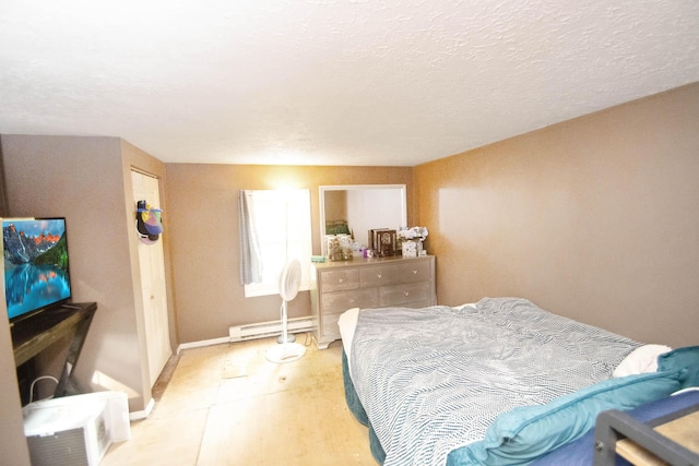 bedroom with baseboards, baseboard heating, a textured ceiling, and light floors