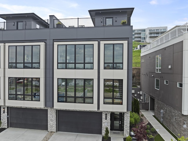 exterior space featuring a garage, stucco siding, and driveway