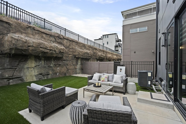view of patio with a fenced backyard, central AC unit, and outdoor lounge area