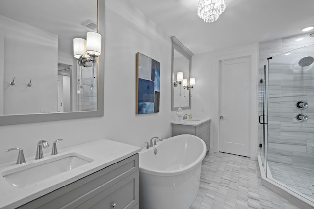 full bath featuring an inviting chandelier, a sink, and a stall shower