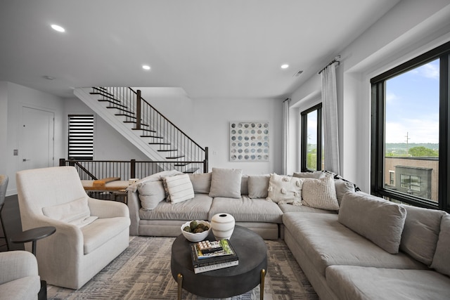 living room with recessed lighting, visible vents, and stairway