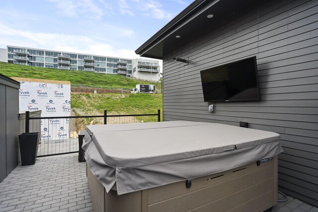deck featuring a hot tub and central air condition unit