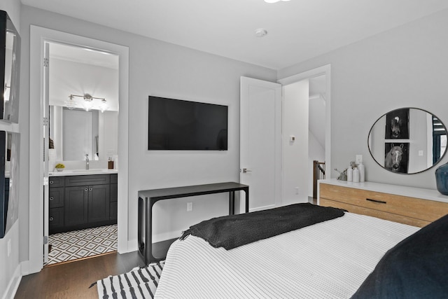 bedroom featuring dark wood-type flooring, a sink, and connected bathroom