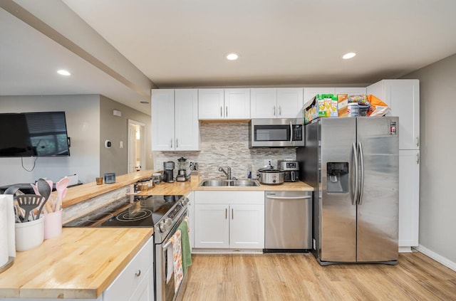 621 Edgecliff Rd, Covington, KY 41014 - kitchen featuring a sink, stainless steel appliances, light wood finished floors, and butcher block countertops
