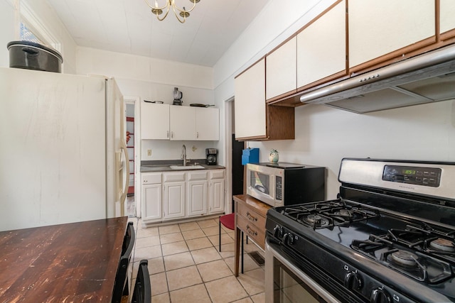 910 Hamlet St, Newport, KY 41071 - kitchen featuring white cabinetry, under cabinet range hood, a sink, appliances with stainless steel finishes, and light tile patterned floors