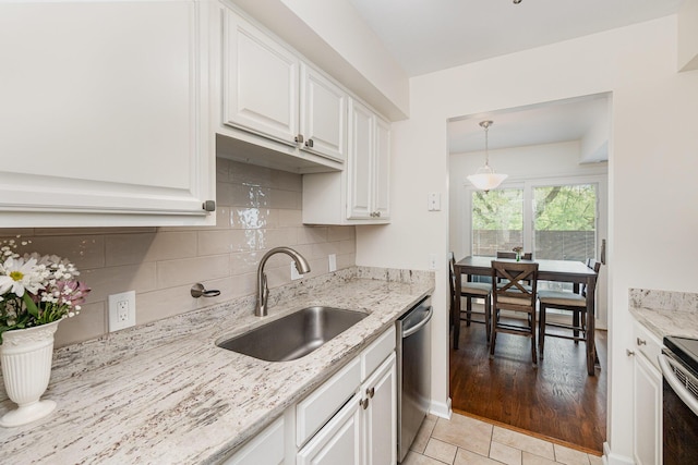 2810 Dry Ridge Ct, Villa Hills, KY 41017 - kitchen featuring appliances with stainless steel finishes, tasteful backsplash, a sink, light stone counters, and white cabinetry
